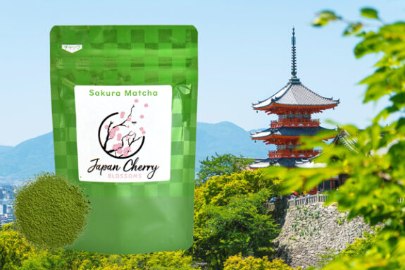A bag of Sakura Matcha Japan Cherry Blossoms is displayed against a backdrop of a traditional Japanese pagoda and lush greenery.
