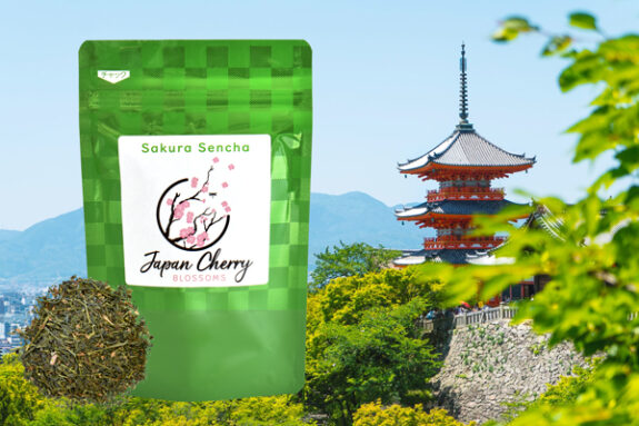 A bag of Japan Cherry Blossoms Sakura Sencha tea is showcased against a backdrop of a traditional Japanese pagoda and lush greenery.